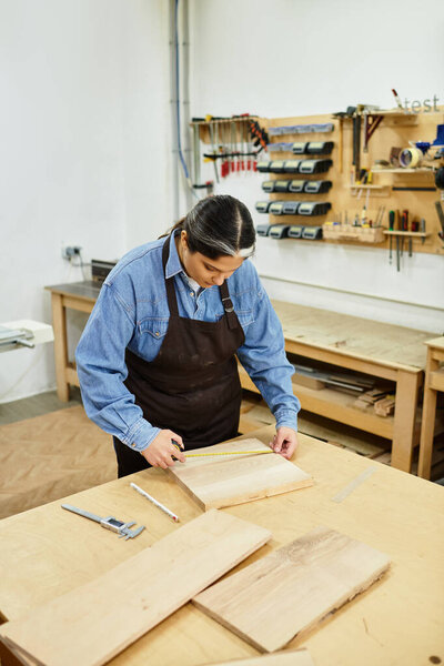 Young woman perfects her craft in a woodworking workshop, showcasing creativity and precision.