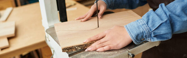 A talented young woman focuses on her woodwork in a bright and engaging workshop space.