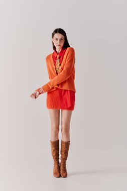 This stylish beautiful woman poses gracefully in an elegant outfit, highlighting her unique charm.