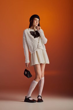 Stylish young woman confidently displays her unique elegance in a stunning setting.