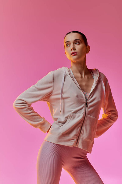 Beautiful woman showcases her fashion sense in cozy attire while striking a stylish pose.