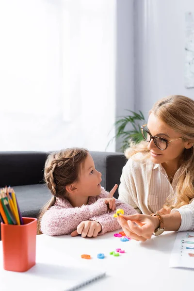 Girl patient calculating with figures while visiting psychologist — Stock Photo