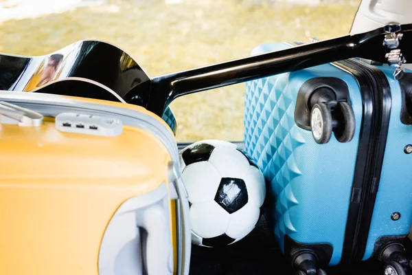 Football, suitcases and acoustic guitar in car trunk — Stock Photo