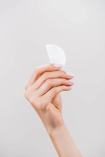 Cropped view of woman holding cotton pad isolated on grey — Stock Photo