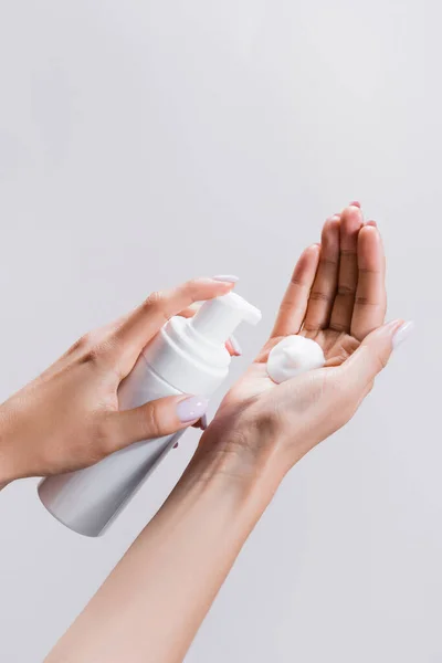 Cropped view of woman applying cleansing foam isolated on grey — Stock Photo