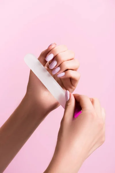 Cropped view of woman using nail file isolated on pink — Stock Photo