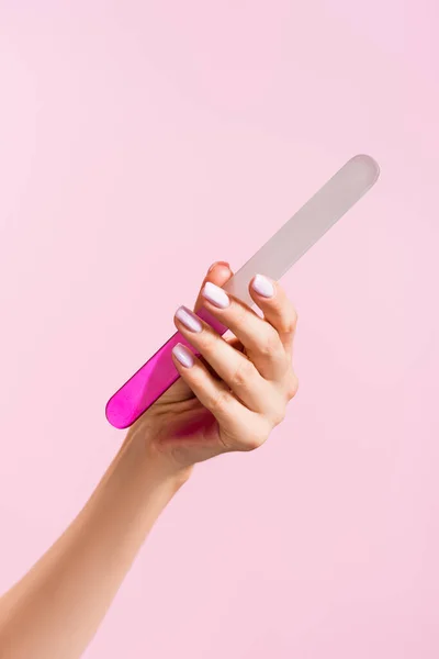 Cropped view of woman holding nail file isolated on pink — Stock Photo