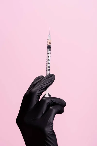 Cropped view of hand in black latex glove with syringe isolated on pink — Stock Photo