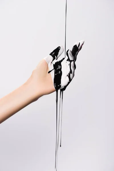 Cropped view of hand with dripping black paint isolated on white — Stock Photo