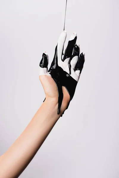 Cropped view of hand with dripping black paint isolated on white — Stock Photo