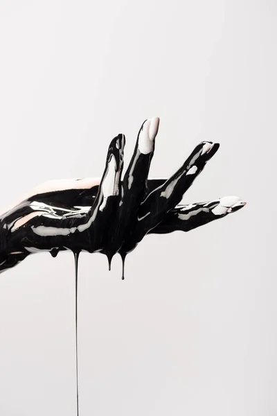 Cropped view of hand with dripping black paint isolated on white — Stock Photo