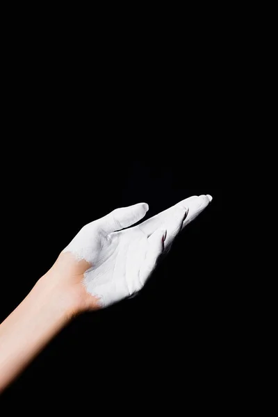 Partial view of white painted hand isolated on black — Stock Photo