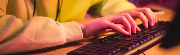 Cropped view of gamer using computer keyboard at table, banner — Stock Photo