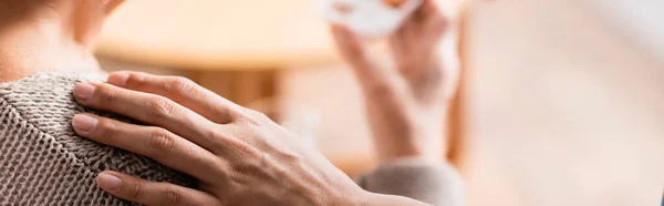 Teilaufnahme einer Krankenschwester, die auf verschwommenem Hintergrund die Schulter einer Seniorin berührt, Banner — Stockfoto