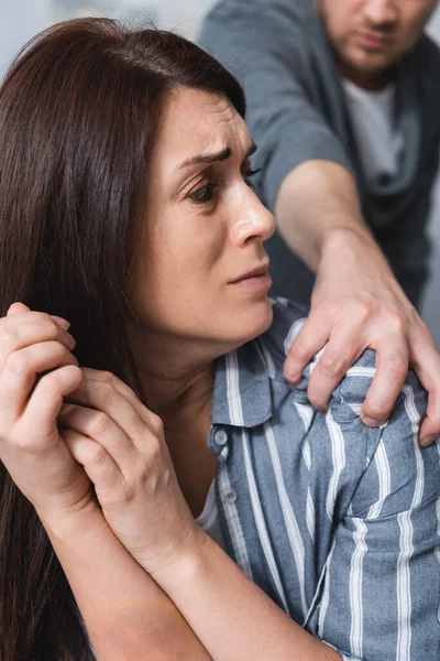Abusive husband grabbing frightened wife at home — Stock Photo