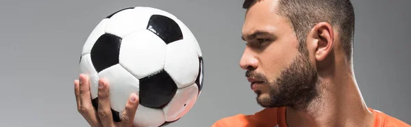 Bearded man looking at football isolated on grey, banner — Stock Photo