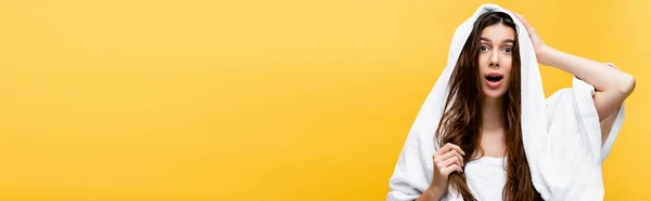 Beautiful woman with wet hair and towel isolated on yellow — Stock Photo