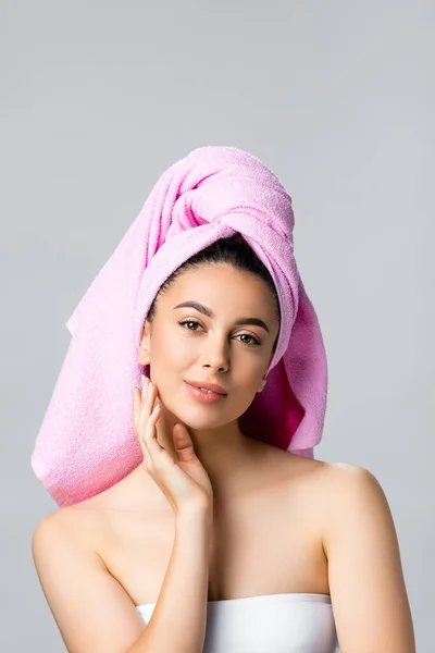 Beautiful woman with towel on hair touching face isolated on grey — Stock Photo