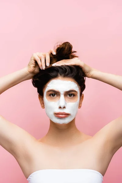 Sad beautiful woman with clay mask on face isolated on pink — Stock Photo