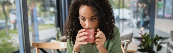African american woman drinking coffee from cup in cafe, banner — Stock Photo