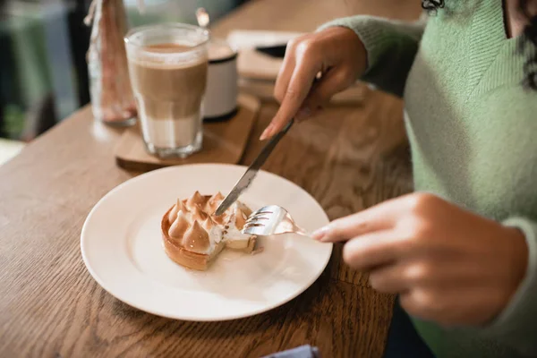 Cropped view of african american woman holding cutlery near tart on plate — Stock Photo