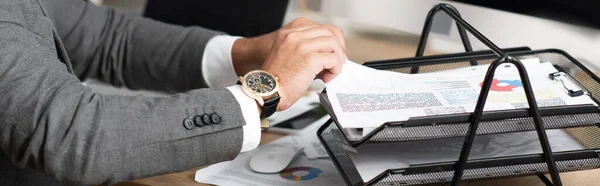 Partial view of trader taking infographics from documents tray, banner — Stock Photo