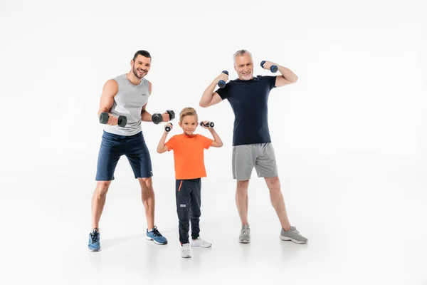 Happy boy with grandfather and dad exercising with dumbbells on white — Stock Photo