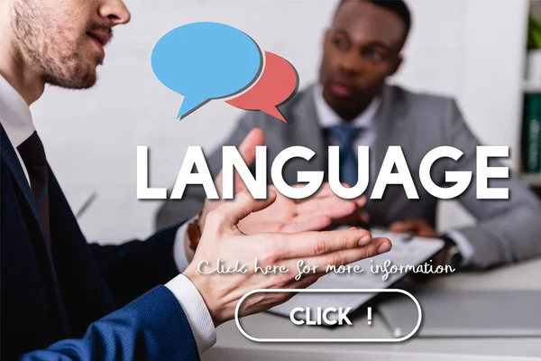 Translator gesturing near african american business partner on blurred background, speech bubbles near language lettering and click icon illustration — Stock Photo