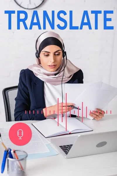 Arabian interpreter in headset working with documents near notebook and laptop, translate lettering near microphone and volume scale illustration — Stock Photo