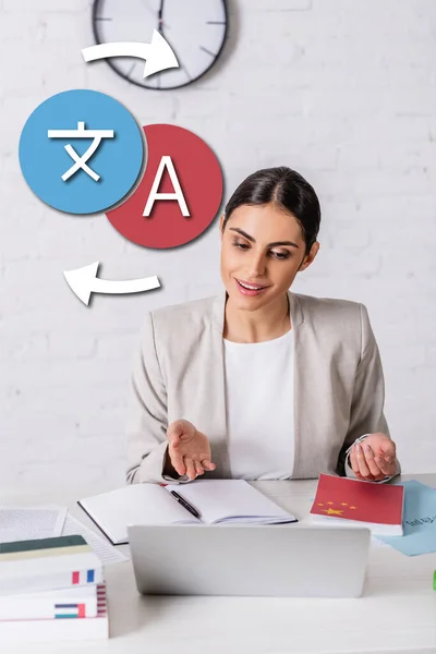 Happy interpreter pointing with hand near notebook and laptop, icons with arrows illustration — Stock Photo