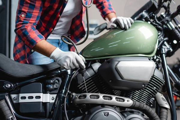 Partial view of mechanic making diagnostics of motorbike engine with stethoscope — Stock Photo