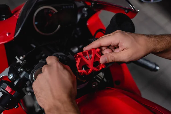 Cropped view of mechanic checking motorcycle handlebar mechanism — Stock Photo