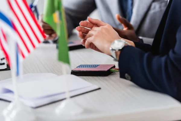 Cropped view of interpreter near digital translator and african american businessman on blurred background — Stock Photo