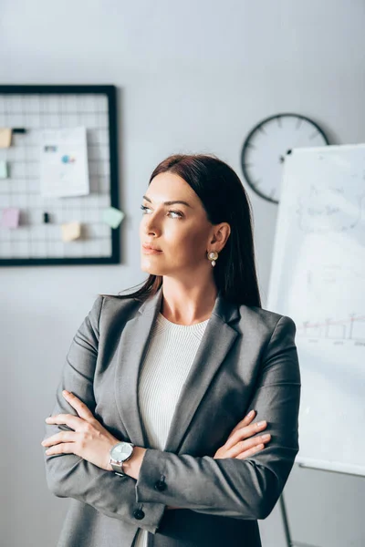 Businesswoman looking away while standing in office — Stock Photo