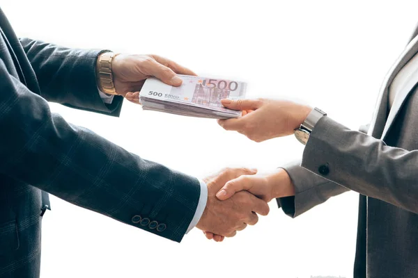 Cropped view of investor giving money and handshaking with businesswoman isolated on white — Stock Photo