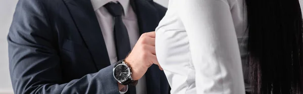 Cropped view of businessman touching bust of businesswoman in blouse, banner — Stock Photo