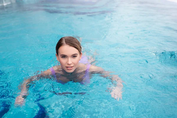 Young woman swimming in water of hot spring pool — Stock Photo