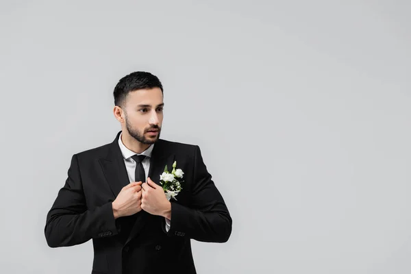 Arabian groom looking away while wearing jacket isolated on grey — Stock Photo