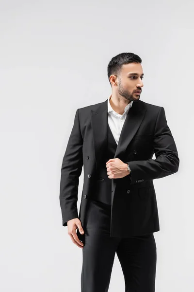 Fashionable muslim man looking away while walking isolated on grey — Stock Photo