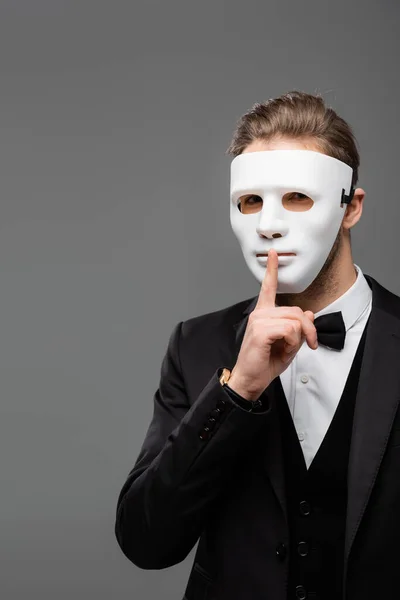 Businessman in face mask showing hush sign isolated on grey — Stock Photo