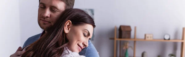 Adult man embracing wife with closed eyes at home, banner — Stock Photo