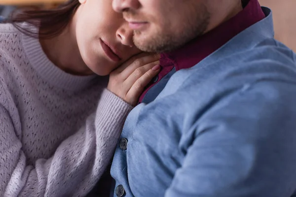 Cropped view of woman touching shoulder of husband on blurred foreground — Stock Photo