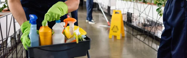 Cropped view of cleaner opening detergent in office, banner — Stock Photo