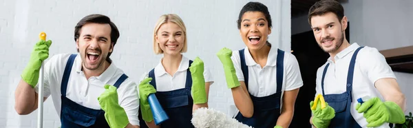 Multiethnic workers of cleaning company showing yes gesture in office, banner — Stock Photo