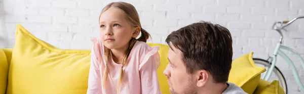 Unpleased girl looking away near father at home, banner — стоковое фото
