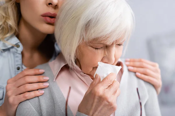 Senior woman with napkin crying near daughter — Stock Photo