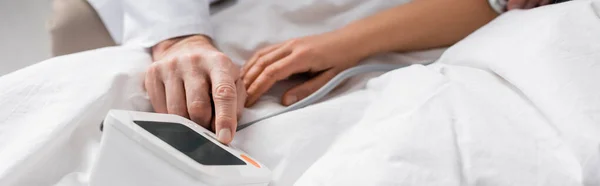 Partial view of doctor measuring blood pressure and heartbeat rate of patient, banner — Stock Photo