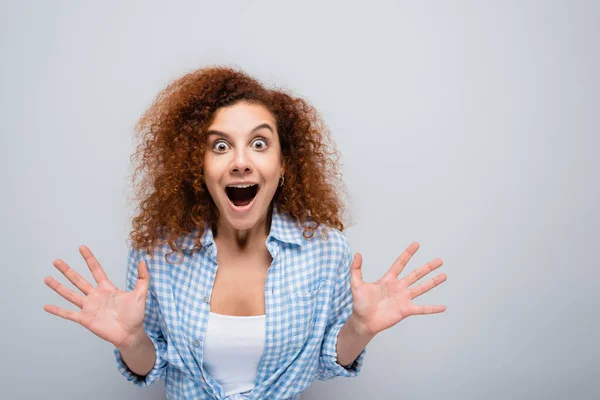 Astonished woman with open mouth showing wow gesture isolated on grey — Stock Photo