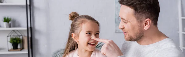 Cheerful father touching nose of daughter, banner — Stock Photo