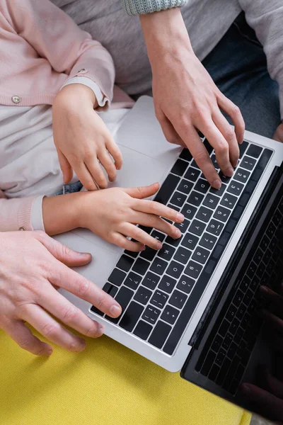 Cropped view of family with daughter using laptop — Stock Photo